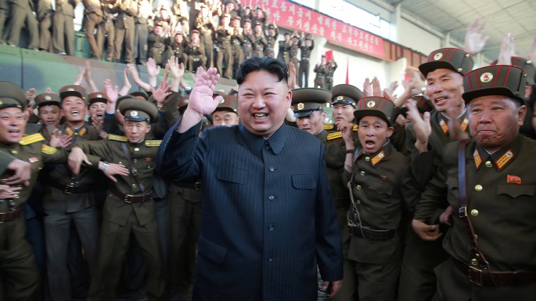 North Korean leader Kim Jong Un reacts with members of the Korean People's Army